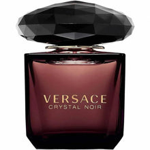 Perfume eau de toilette bottle with faceted black cap and dark maroon glass, gold logo