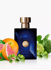 Versace Dylan Blue for men 100ml fragrance bottle with citrus fruits and green leaves for a fresh scent
