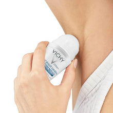 Vichy mineral deodorant bottle applying deodorant to underarm