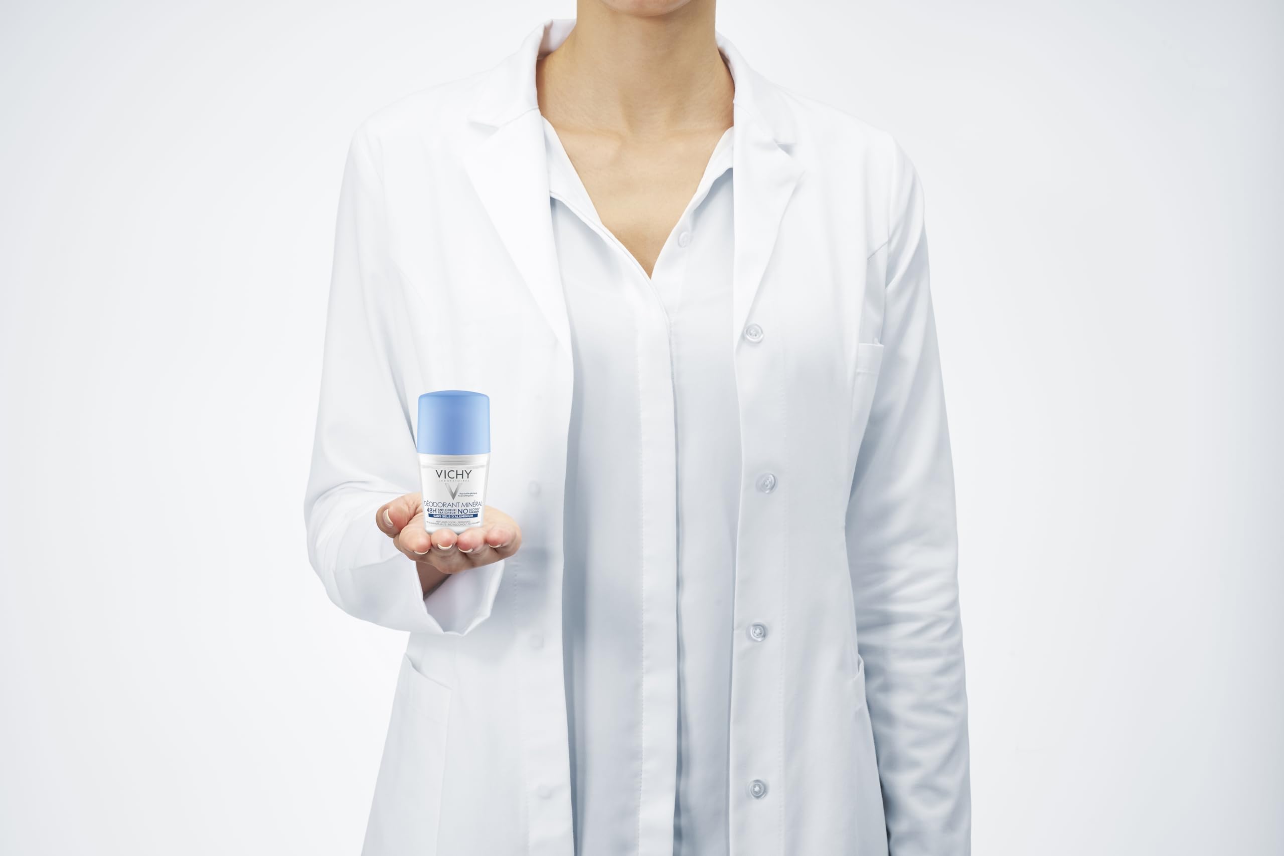 Vichy 48 hour aluminum free deodorant held by a person in a lab coat for sensitive skin protection