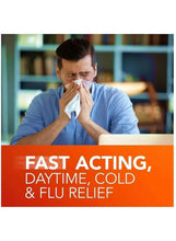 Person blowing nose with tissue, fast acting day or night cold and flu relief