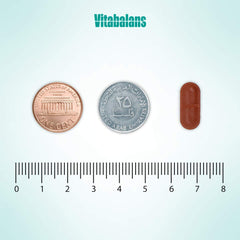 Vitabalans iron bisglycinate supplement UAE brown capsule size comparison next to US penny 25 fils coin and ruler
