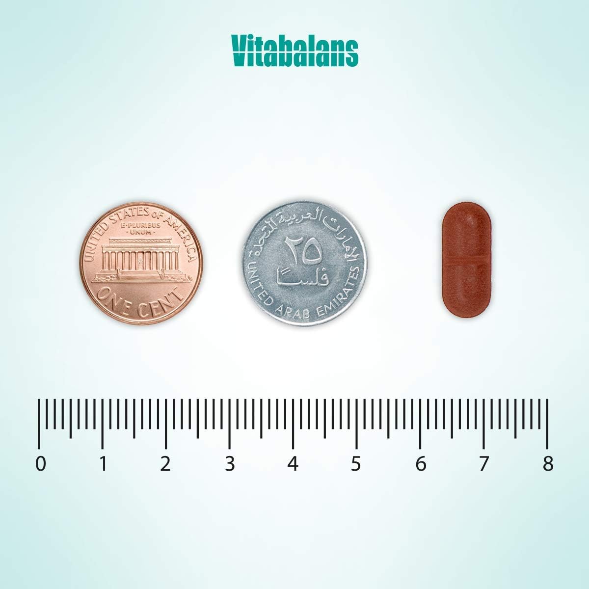 Vitabalans iron bisglycinate supplement UAE brown oval tablet size comparison with US penny UAE 25 fils coin and ruler