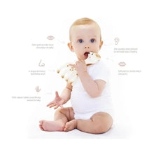 Baby holding a white giraffe teether with orange-brown spots and small horns