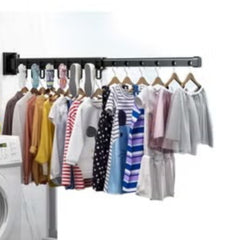 Huitich wall mounted clothes hanger with multiple garments hanging and drying in a laundry room