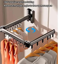 Wall-mounted foldable clothes hanger rack showing pivoting folded corner bracket and hooks