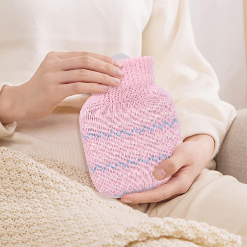 Photken mini hot water bottle with knitted cover pink zigzag pattern held by person on sofa