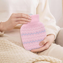 Pink mini hot water bottle with knitted cover and blue zigzag stripe