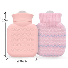 Pink hot water bottle and pink knitted cover with blue zigzag pattern