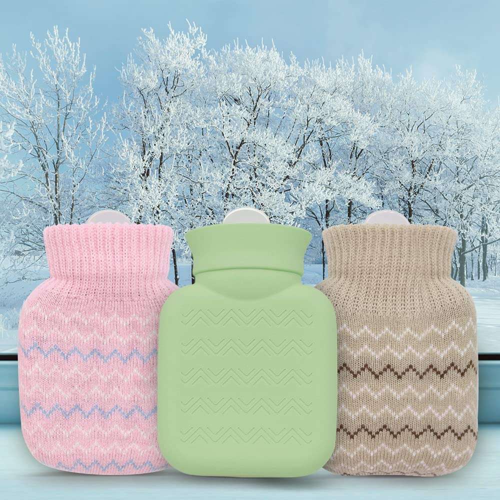 Photken mini hot water bottle with knitted cover pink and beige paired with green bottle on snowy background