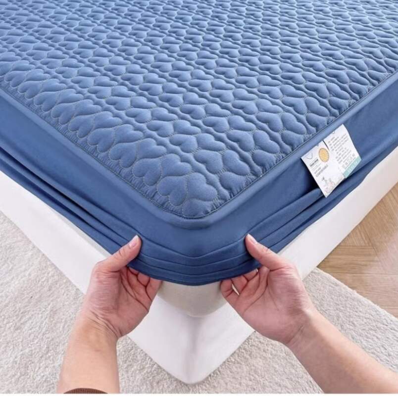 Huitich waterproof king size mattress topper with quilted blue fitted sheet being placed on mattress