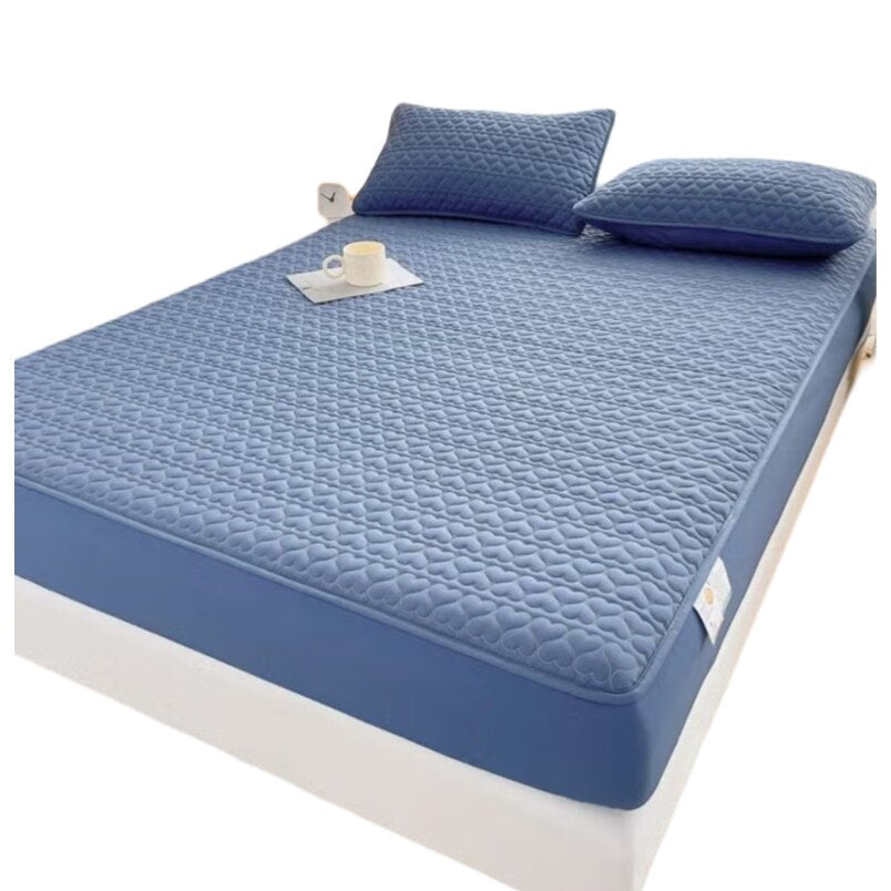 Huitich fitted sheets on a waterproof king size mattress topper with matching blue pillows
