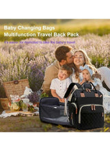 Black quilted maternity travel backpack with front pockets and brown handle pull tabs