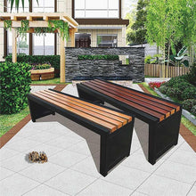Outdoor bench with orange slatted top and dark steel legs