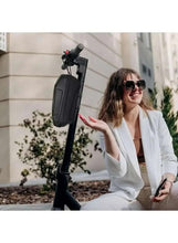 Dark scooter front bag with hard shell and zip top mounted on handlebar