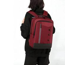 Maroon and black waterproof backpack worn on back, with front zipper pocket and side straps