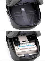 Dark grey travel backpack interior showing storage pockets for devices and documents