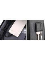 Dark grey backpack charging port opening with connected cable