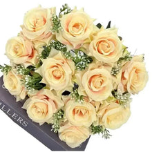 Artificial wedding flower bouquet with cream roses and green leafy accents