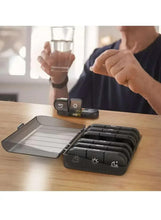 Black portable pill organizer with open lid and stacked pill compartments