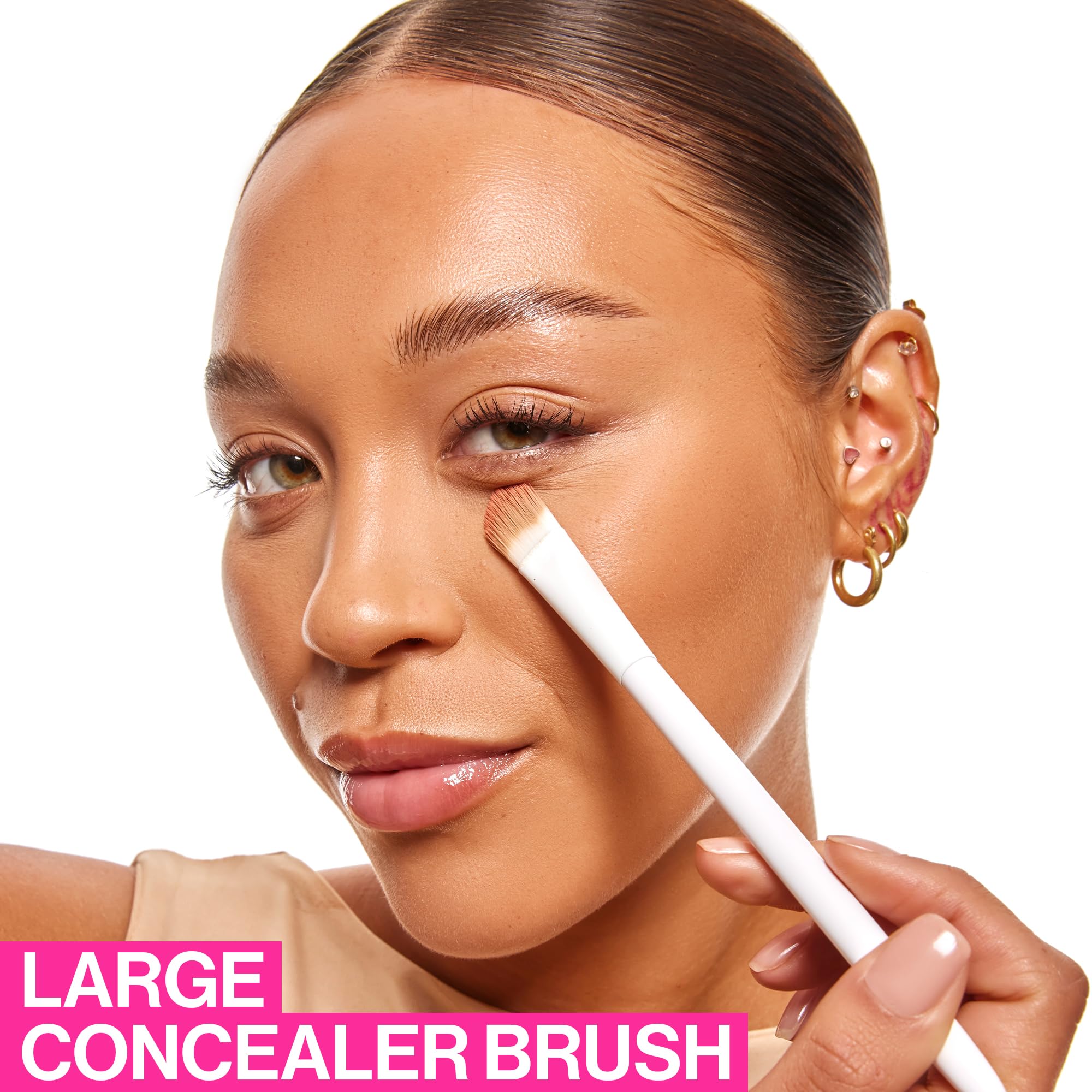 Markwins Beauty large concealer brush for under eyes applying makeup on model's face