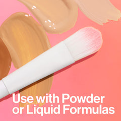 Concealer brush for under eyes with soft white and pink bristles on beige makeup swatches