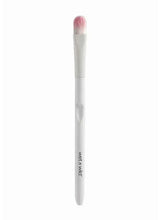 Eyeshadow makeup brush with white handle and pink bristles.