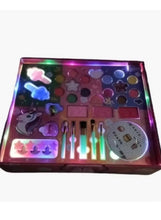 Girls beauty set case with colorful makeup palette, lip colors, brushes, and compact mirror