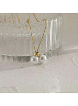 Gold lariat necklace with two white pearl drops on a Y-shaped chain