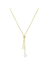 Gold lariat necklace with dual pearl drops and round clasp charm