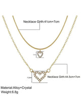 Gold-tone layered necklace featuring a small and large crystal heart pendant