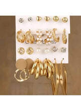Earrings set flat lay: gold hoops, pearl clusters, and round stud earrings