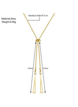Gold-tone triangle pendant necklace with two long tassel-style drop pendants