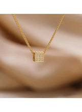 Gold cube pendant necklace with rhinestone inset, geometric square front