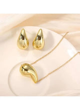 Gold-tone waterdrop stud earrings with matching pendant necklace, glossy sculpted drops
