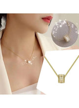Gold-tone necklace with crystal pendant, featuring a crown-like centerpiece