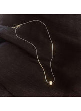 Gold-tone chain necklace with small round crystal pendant