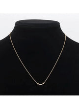 Gold chain necklace with curved rhinestone bar pendant and small end links