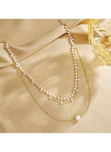 Triple-layer pearl choker necklace with gold-tone chain and pearl bead-strand loops
