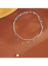 Triple-layer pearl choker necklace with bead loops and long chain pendant pearl