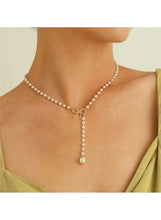 Faux pearl Y-necklace with bow pendant and three-tier pearl drops