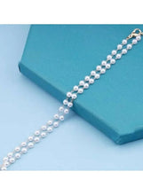 Faux pearl beaded necklace with repeating pearl rows and clasp