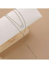 Y-shaped lariat necklace with round pearl drop at center and thin long chain