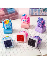 Set of colorful pony-shaped self-inking stamp blocks with ink pads on paper