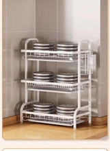 2-tier dish drying rack holding plates and bowls, white wire frame