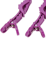 Purple hair sectioning clip close-up with metal spring and serrated teeth
