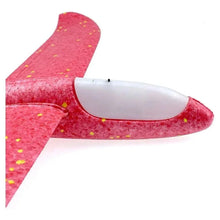 Red glitter foam glider plane with white LED nose, wing detail, hand-launch toy