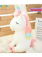 White unicorn plush toy with pastel horn and rainbow-striped legs, stitched closed-eye face
