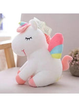 White unicorn plush toy with pastel rainbow horn and hooves, with hanging care tag