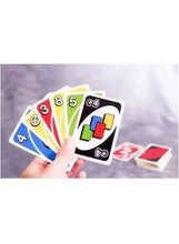 Hand holding fanned card game cards with colored number faces